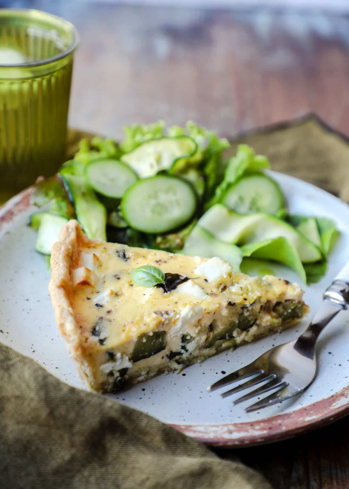 Courgette and Feta Tart on plate with salad