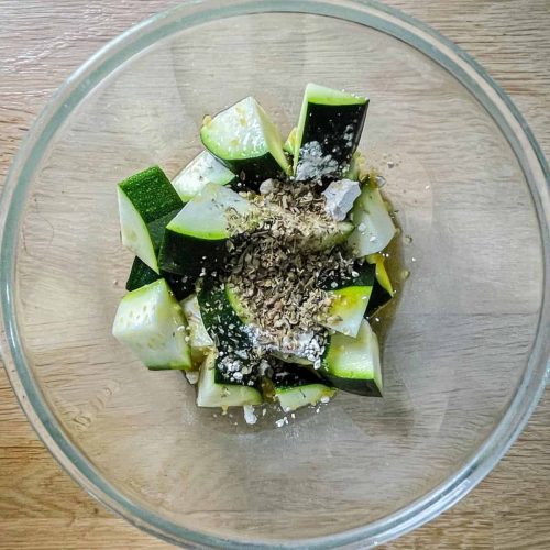 Courgettes in a bowl with herbs