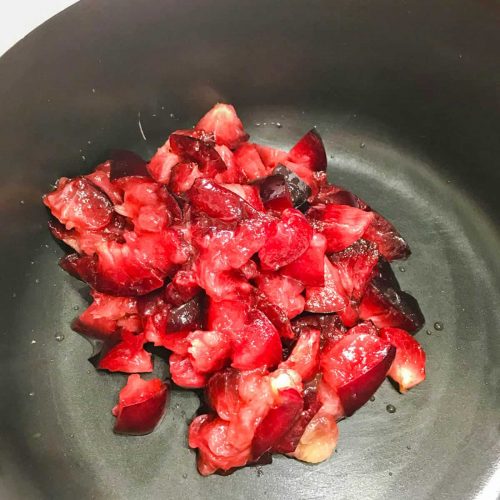 Low sugar plum jam chopped plums in saucepan