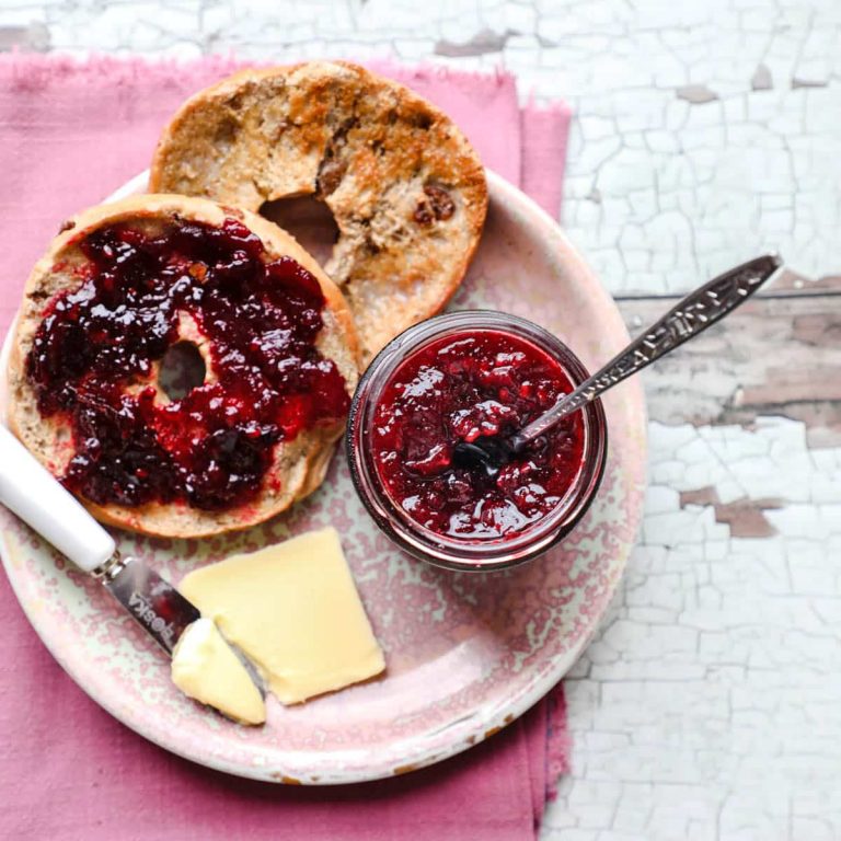Low Sugar Blackberry & apple jam with butter and bagels on plate