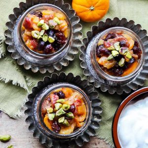 dried fruit compote in jars on metal tart tins with yogurt