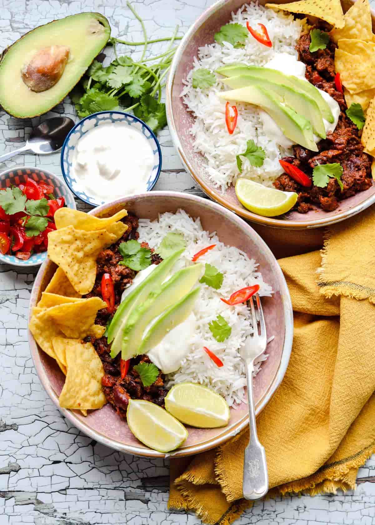 Slow Cooker chilli in bowls with avocado and salsa