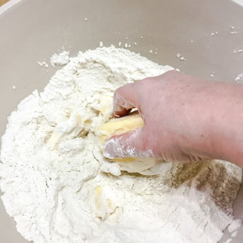 Bowl of flour and butter in hand