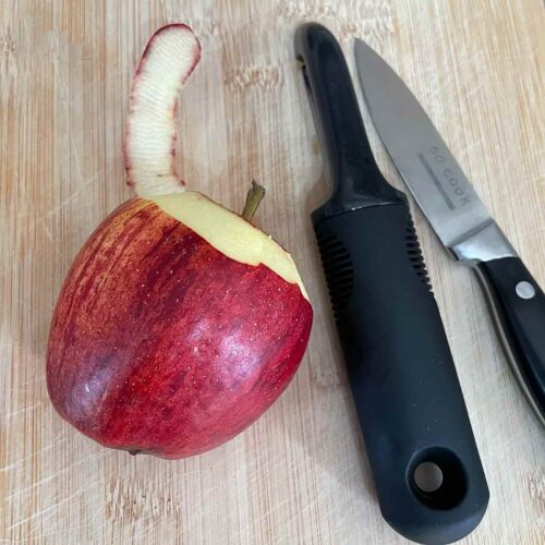 Apple with knife and peeler