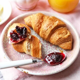 Mixed Red Berry Cherry Jam with croissants on plate