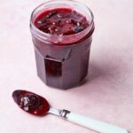Mixed Red Berry Cherry Jam with spoon of jam