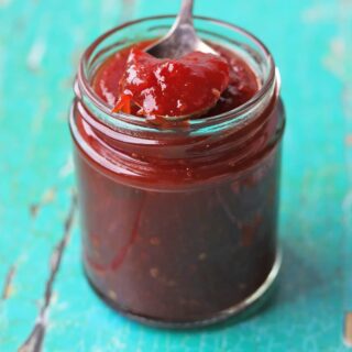 Tomato chilli jam in jar with spoon
