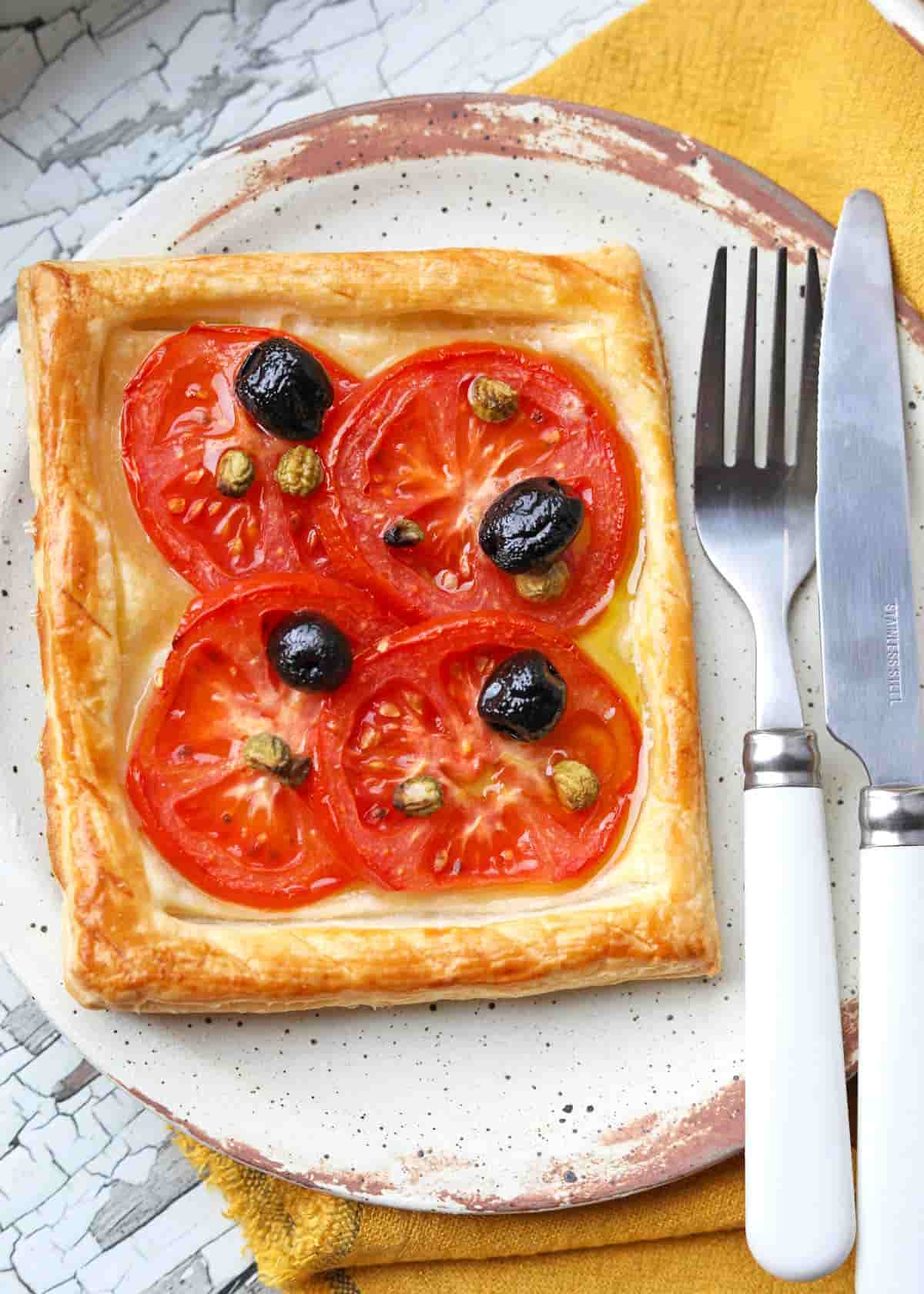 Tomato Tart with olives on plate