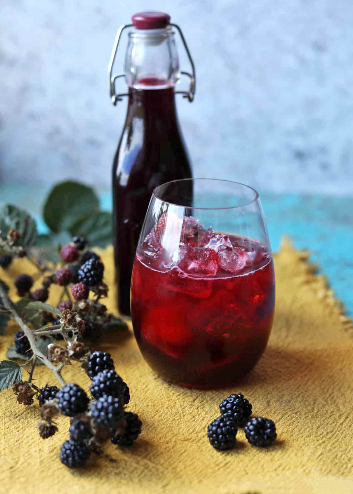 Blacberry and vanilla cordial, bottle, glass and blackberries