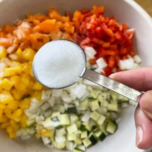 salt and chopped vegetables for Courgette Relish