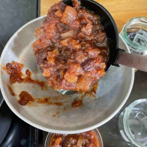 slow Cooker Date and Apple Chutney ladle into jars