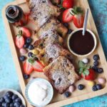 Air Fryer Hot Cross Bun French Toast on tray with strawberries and blueberries