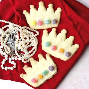 Coronation Cookies, three crowns on red velvet with pearls