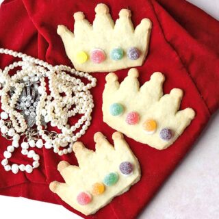 Coronation Cookies, three crowns on red velvet with pearls