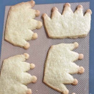 Baked Coronation Cookies (shortbread crowns) on baking sheet