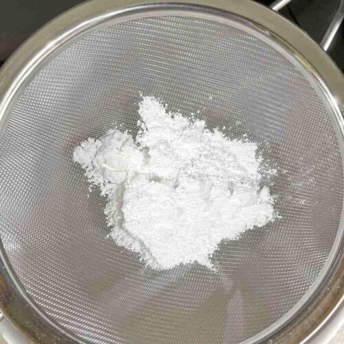icing sugar in sieve