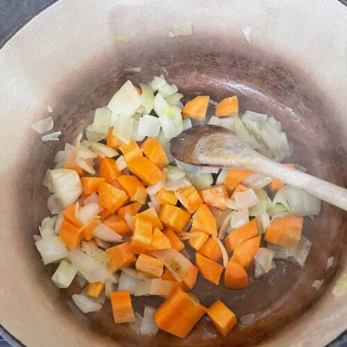 carrots and onions with butter in pan