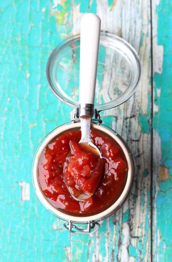 Tomato Chutney spoon on top of jar