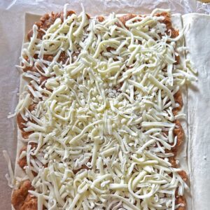 puff pastry covered with chorizo and grated cheese
