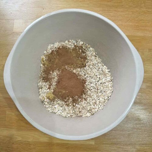Add sprices to bowl of oats
