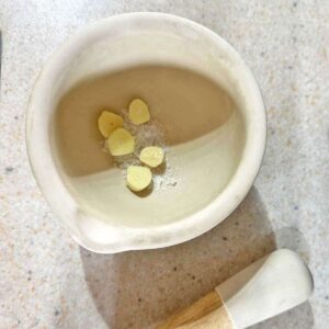 garlic and salt in mortar and pestle