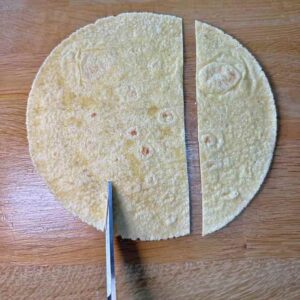 Cut corn tortilla in thirds