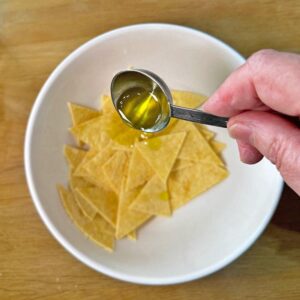 Add oil to tortilla chips