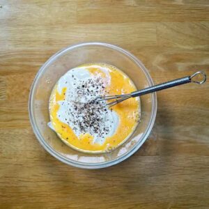 Beaten egg with sour cream and black pepper.