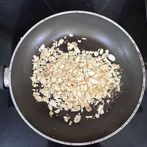 toasted almonds in frying pan.