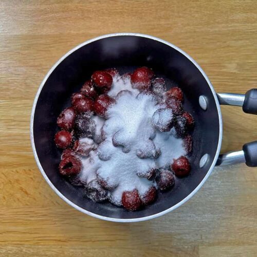 cherry compote - cherries an sugar in pan.