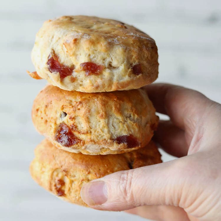 3 air fryer cherry scones held in hand.