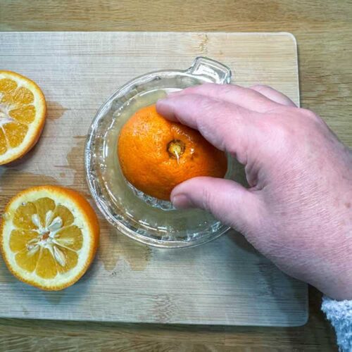 squeeze out juice from seville oranges.