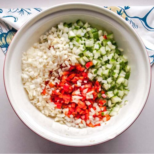 chopped cucumber onions, red pepper in bowl.