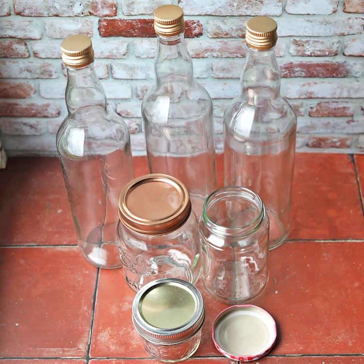 bottles and glass jam jars with lids.