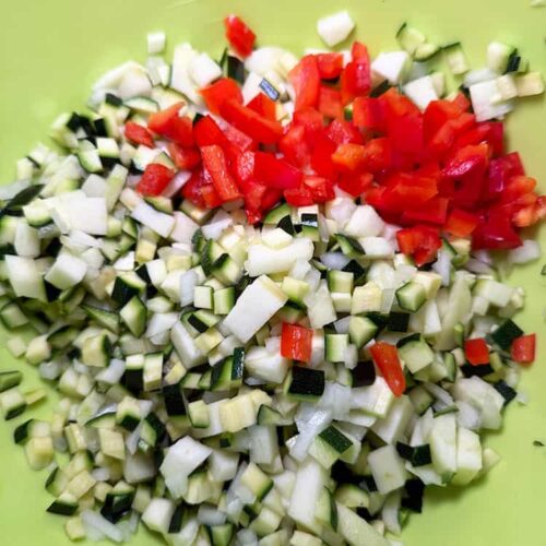 onion, courgette, red pepper chopped in bowl.