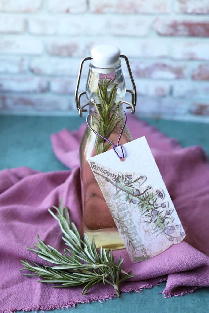 rosemary vinegar in bottle with rosemary sprig.