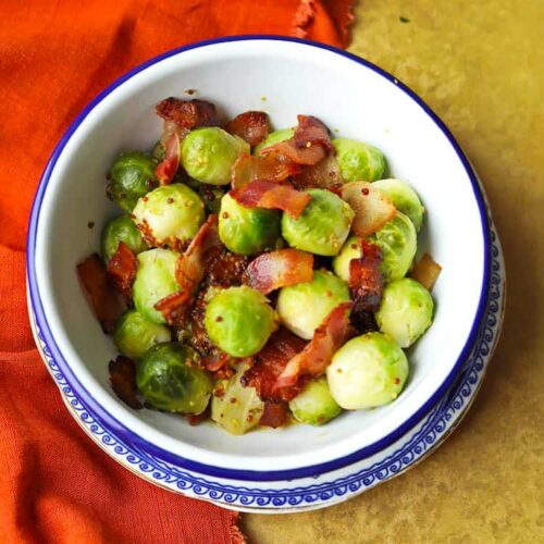 bowl of brussels sprouts with bacon and mustard dressing.