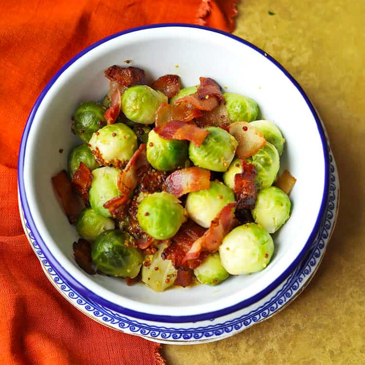 bowl of brussels sprouts with bacon and mustard dressing.