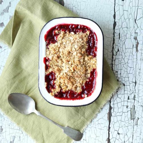 Plum and Orange Oat Crumble with spoon.