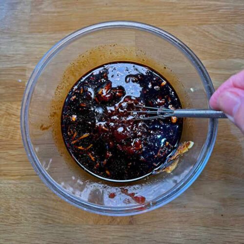 BBQ sauce in jug with whisk.
