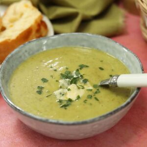 courgette (zucchini) and blue cheese soup in bowl with spoon.